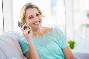 Blonde woman on the phone on the couch