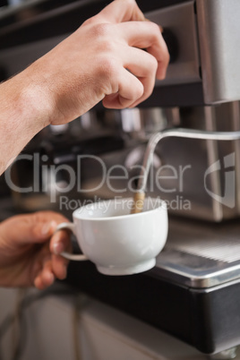 Close up of barista making cup of coffee