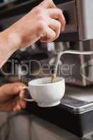 Close up of barista making cup of coffee