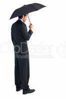 Rear view of classy businessman holding black umbrella