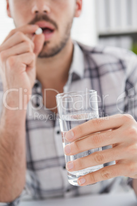 Casual businessman taking a tablet