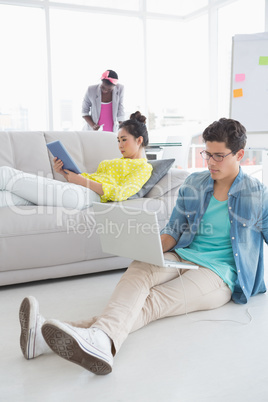 Young creative man working on floor