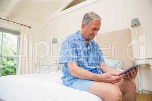 Senior man using tablet pc