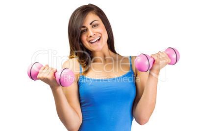 Smiling fit brunette holding dumbbells