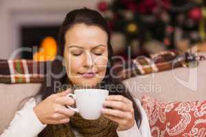 Pretty brunette enjoying hot chocolate