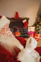 Father christmas holding engagement ring