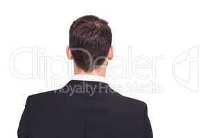 Rear view of businessman in suit standing