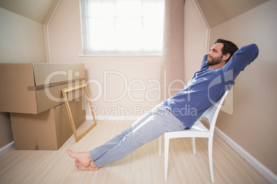 Happy man sitting back after moving in