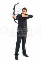 Concentrated handsome businessman practicing archery