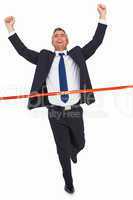 Businessman crossing finish line and cheering