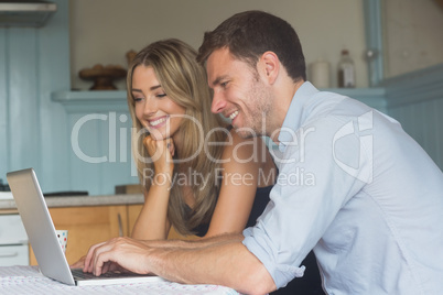 Cute couple using laptop together