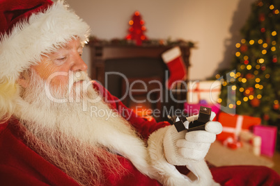 Santa claus holding engagement ring with his box