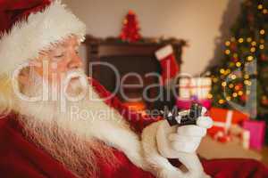 Santa claus holding engagement ring with his box
