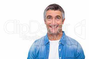 Joyful man in casual clothes looking up