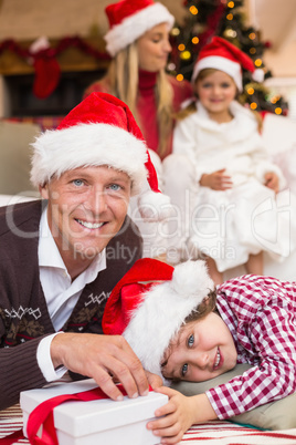 Festive father and son opening christmas present