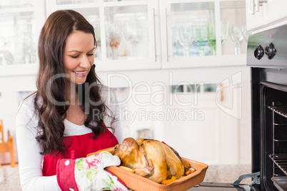 Happy woman holding roast turkey