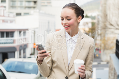 Young businesswoman sending a text