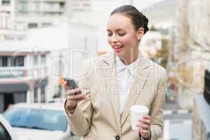 Young businesswoman sending a text