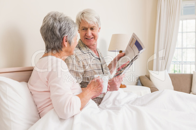 Senior couple relaxing in bed