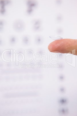 Close up on finger holding contact lens