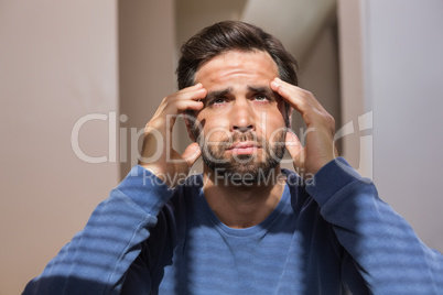 Depressed man sitting on floor