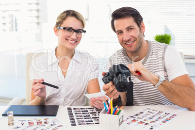 Portrait of photo editors with camera