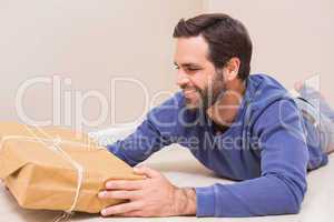 Happy man looking at package
