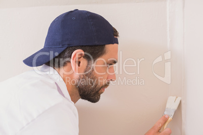 Painter painting the walls white