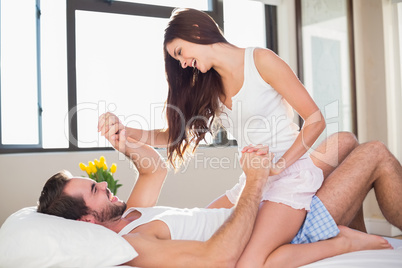 Young couple having fun in bed