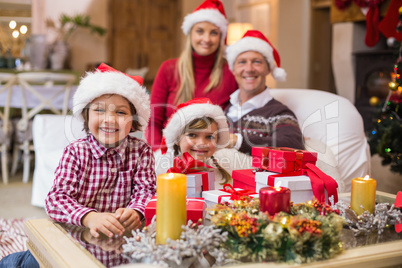Portrait of a festive family in santa hat