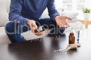 Man with his medicine laid out on coffee table