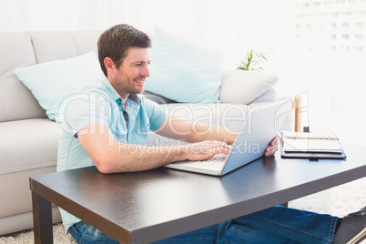 Smiling man sitting on the floor at home