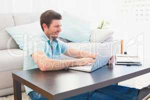 Smiling man sitting on the floor at home