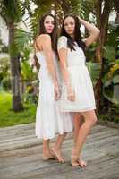 Pretty friends posing in white dresses