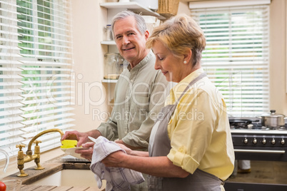 Senior couple washing the dishes