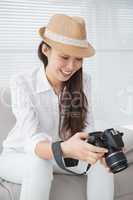 Photo editor looking at her camera