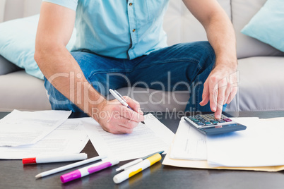 A man counting his bills at home