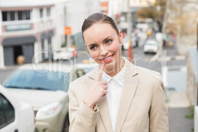 Young businesswoman smiling and thinking