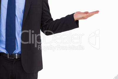 Businessman holding hand out in presentation