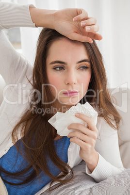 Sick brunette on the couch