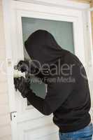 Burglar breaking open the door