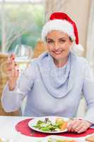 Pretty young woman in santa hat toasting with white wine