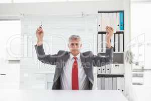 Mature businessman holding pen and book