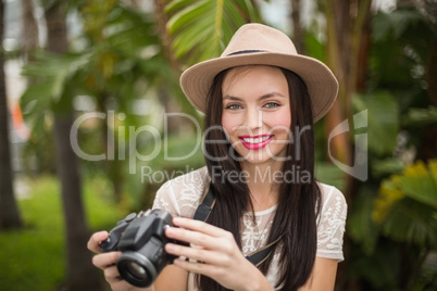 Pretty brunette holding her camera