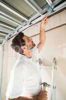 Construction worker fixing the ceiling