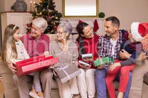 Festive family opening gifts at christmas