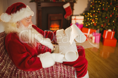 Santa claus reading his list at christmas