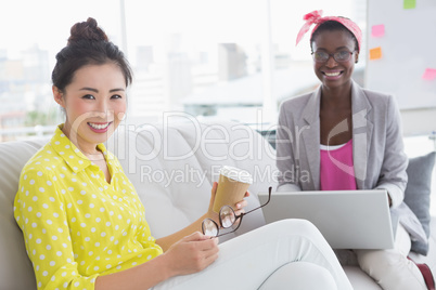 Young creative women chatting on the couch