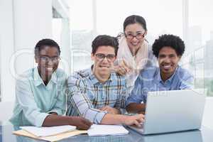 Casual business team working together at desk