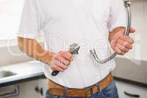 Plumber fixing pipe with wrench